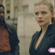 A man and a woman standing together, looking concerned